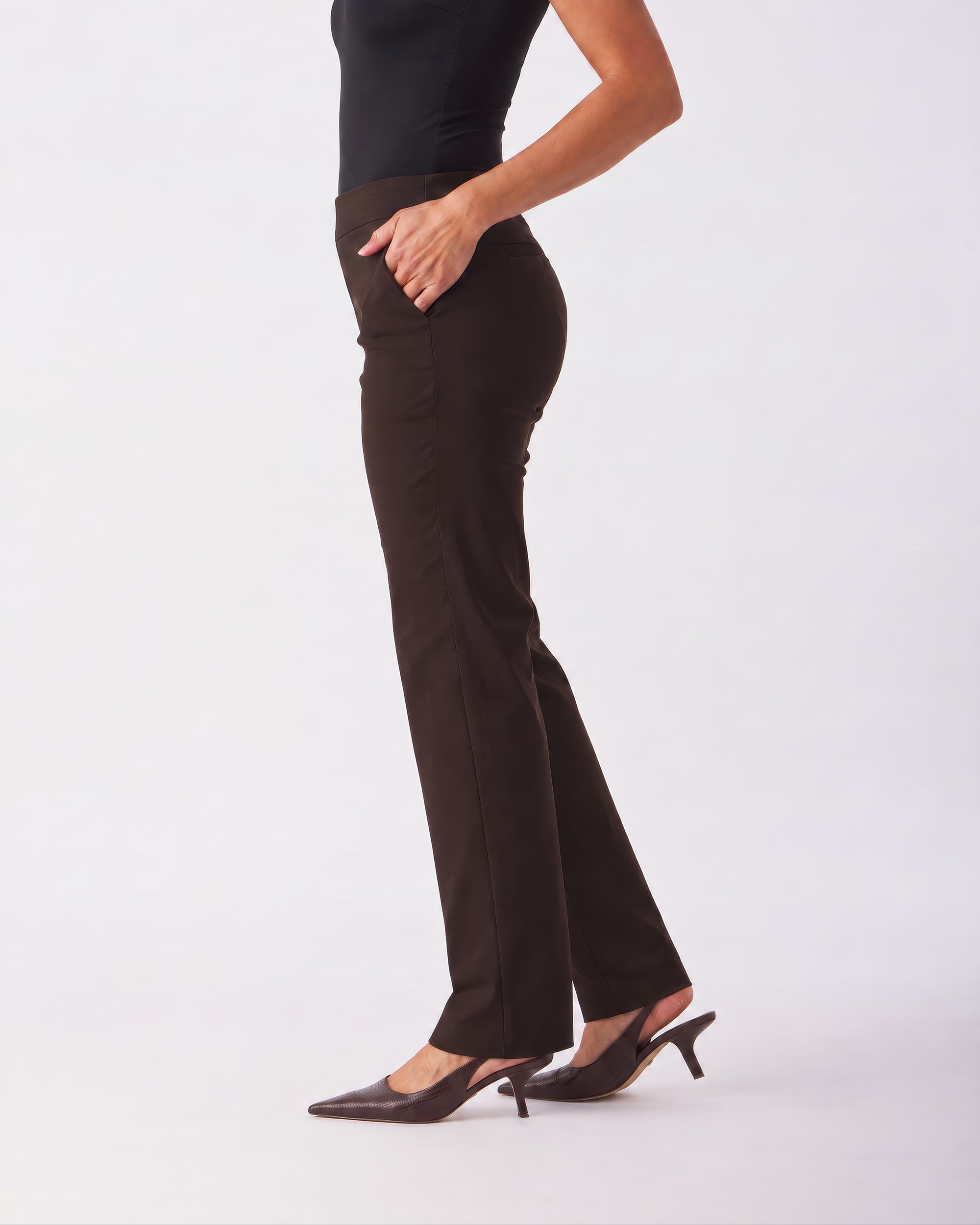 A model shown from the waist down wearing dark brown flared trousers, a black top, and dark brown slingback heels against a plain white studio background.