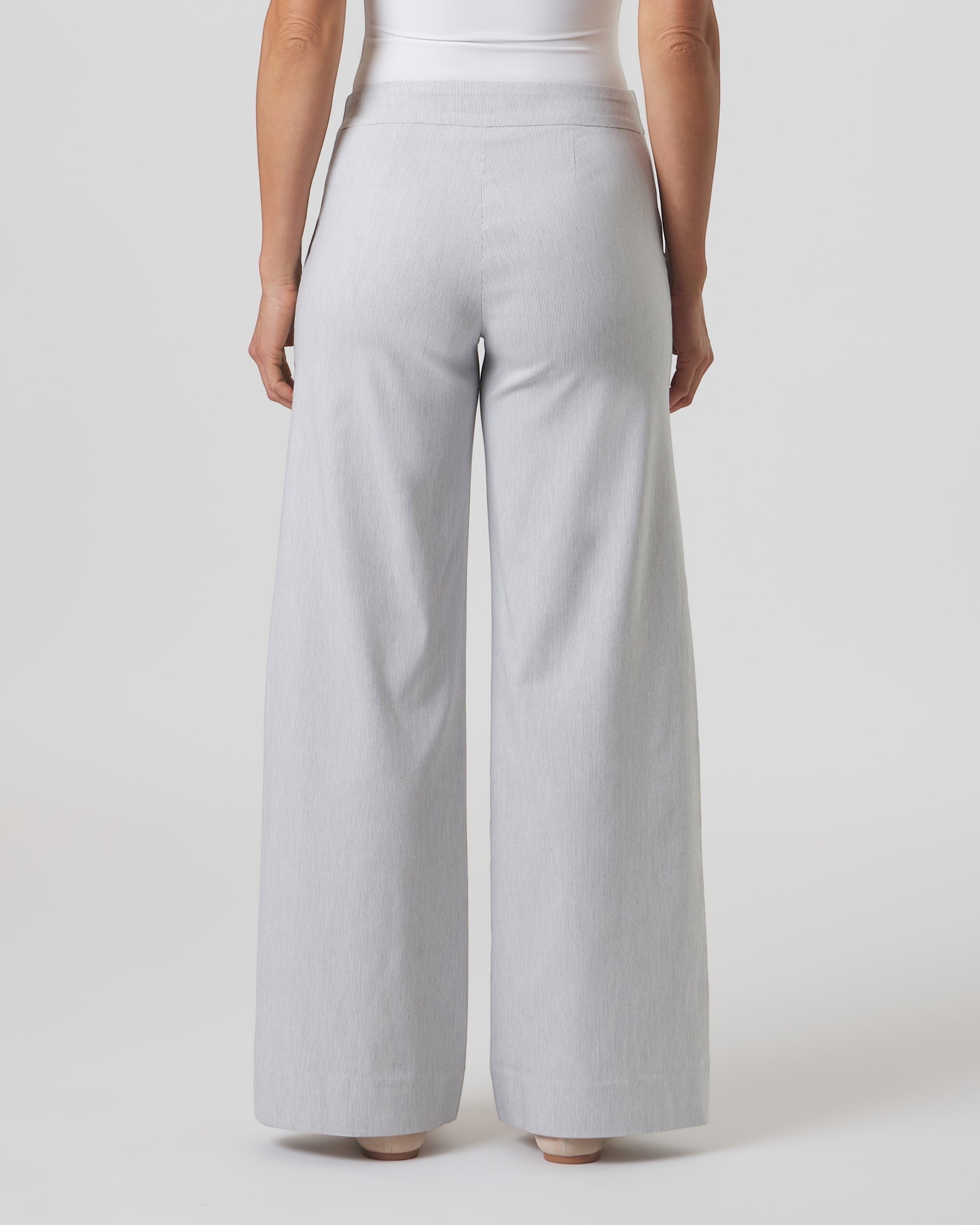 Back view of Franne Golde Mayfair wide leg pants in light grey pinstripe stretch fabric with a contoured waistband.